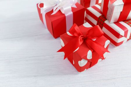 Red gift boxes on white wooden table backgroundの写真素材