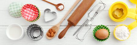 Baking ingredients and utensils on white wooden tableの写真素材