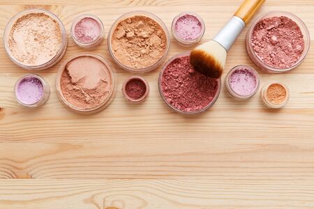 Makeup powder products with foundation blush and brush on wood backgroundの写真素材