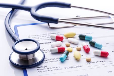 Medicine on medical form with stethoscopeの写真素材
