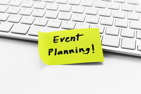 Event planning word on notepad on white computer deskの写真素材
