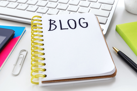 Blog word on notebook on white computer desk with penの写真素材