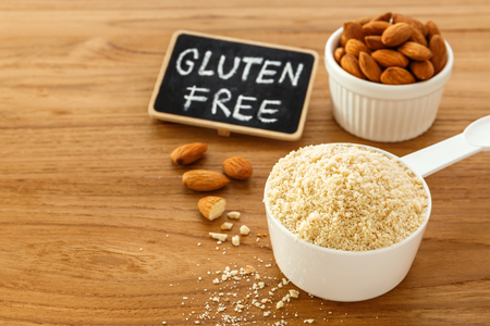 Almond flour with almonds and gluten free sign on wooden table backgroundの写真素材