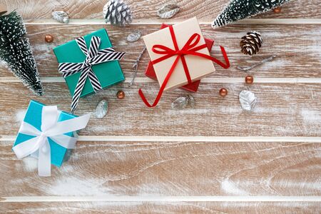 Christmas background with gift box and christmas tree  on wooden table flat lay with copy spaceの写真素材
