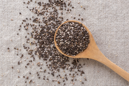 Chia seeds in wooden spoon from top viewの写真素材