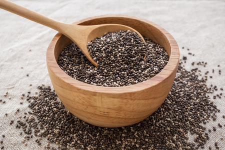 Chia seeds in wooden bowl with spoonの写真素材