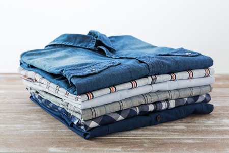 Stack of clothes on wooden tableの写真素材
