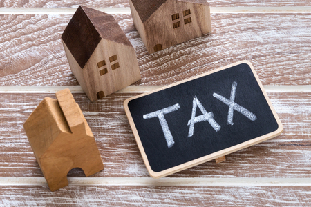 Tax sign with model of houses for property tax conceptの写真素材