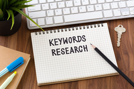 Keywords research words on notebook with computerの写真素材