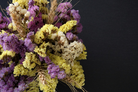 Statice flowers on black stone background from top viewの写真素材
