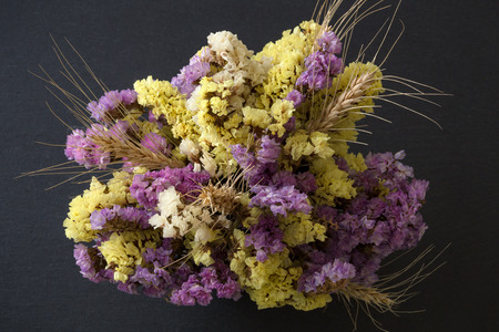 Bouquet of statice flowers on black stone backgroundの写真素材
