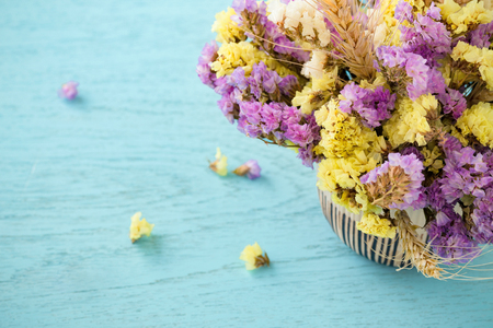 Flowers on blue wooden table backgroundの写真素材