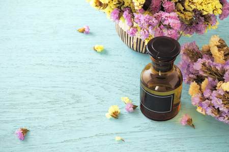 Bottle of essential oil with flower backgroundの写真素材