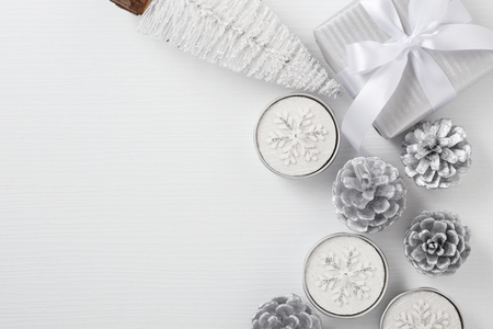 Christmas background with gift box, candle and christmas tree on wood table with space, top viewの写真素材