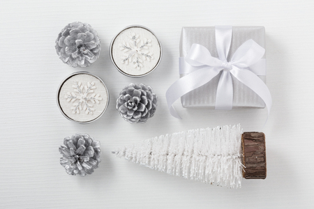 Christmas composition with gift box, candle, pine and christmas tree, white and silver decorationの写真素材