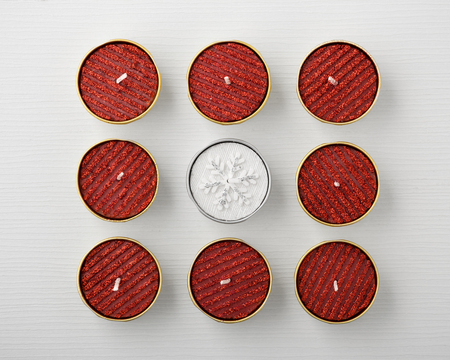 Red and white glitter christmas candles on white table, top viewの写真素材