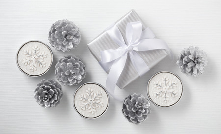 Christmas candle and gift box, white and silver decoration, top viewの写真素材