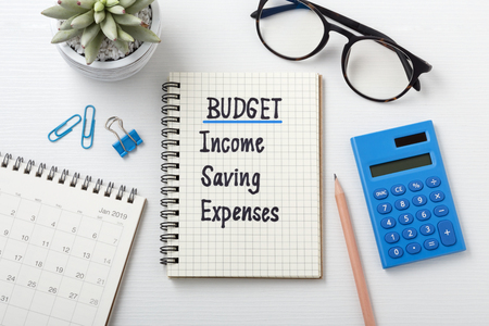 Monthly budget planning 2019 with calculator and calendar on white wooden deskの写真素材