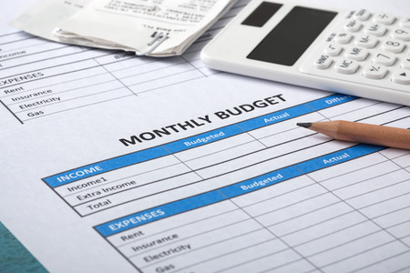 Monthly budget concept with bills and calculatorの写真素材