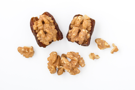 Walnut and dried date fruit with walnuts isolated on white background, top viewの写真素材
