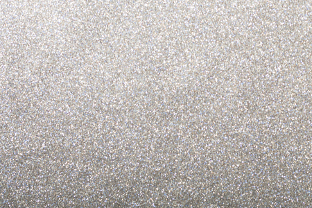 Silver glitter background, shiny wrapping paper defocusedの写真素材