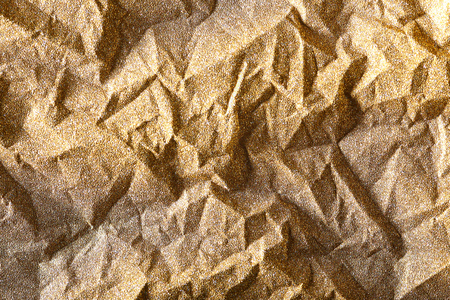 Gold glitter shiny crumpled wrapping paper backgroundの写真素材