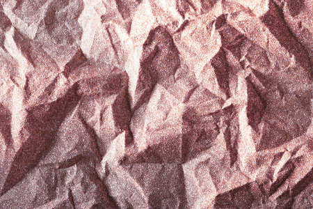 Pink gold glitter shiny crumpled wrapping paper backgroundの写真素材