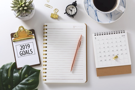 2019 goals text on clipboard with notebook,calendar and pen, flat layの写真素材