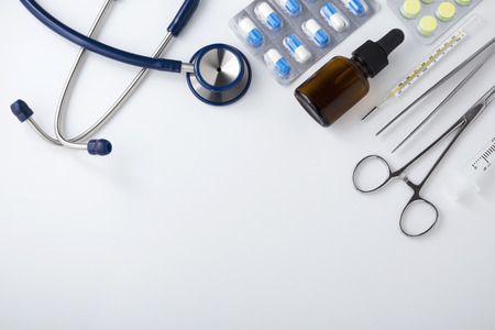 Doctor desk with medical tools and drug, top view with spaceの写真素材