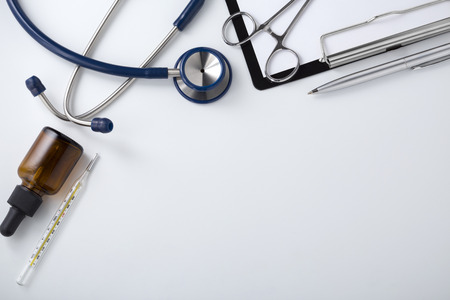 Doctor desk with stethoscope, top view with spaceの写真素材