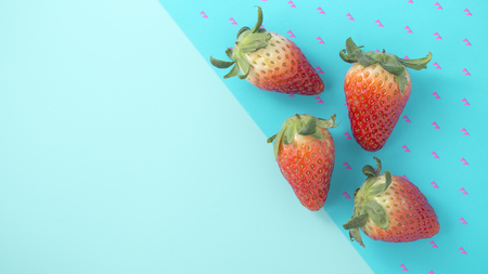 Strawberry on blue background with space, top viewの写真素材