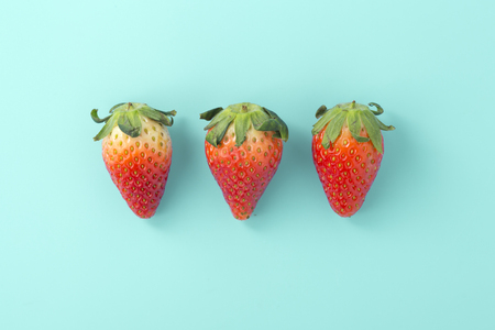 Strawberries on light blue background, flat layの写真素材