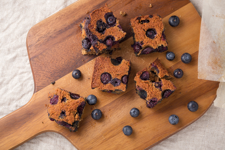 Blueberry square bars on wooden board with blueberries, top viewの写真素材