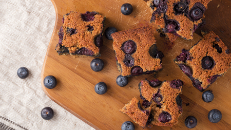 Blueberry square bars on wooden board with blueberries,  paleo low carb dessertの写真素材