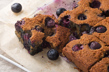 Blueberry square bars on paper baking sheet, paleo low carb dessert with almond flourの写真素材