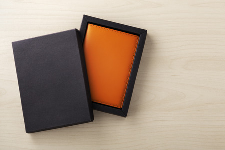 Leather passport case in black box, business gift, on wooden backgroundの写真素材