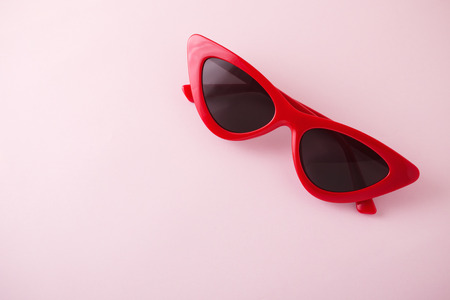 Red cat eye sunglasses on pink backgroundの写真素材