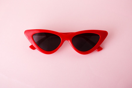 Red retro sunglasses on pink backgroundの写真素材