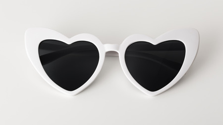 White heart shaped sunglasses on white backgroundの写真素材