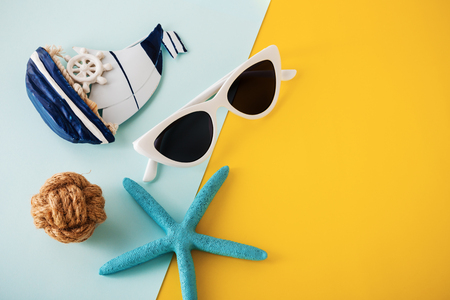 Summer holiday travel concept with sunglasses and accessories on yellow background, top viewの写真素材