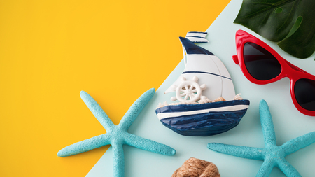 Summer holiday travel concept on yellow and blue background with copyspaceの写真素材