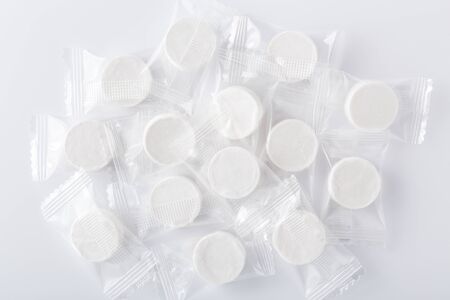 Compressed dry facial mask in package on white backgroundの写真素材