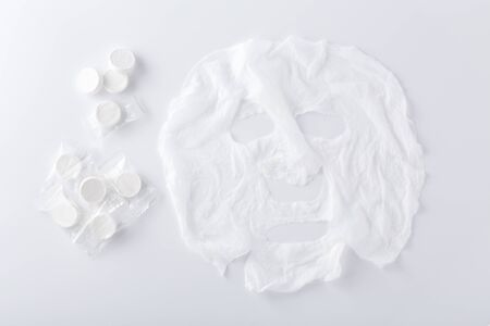Facial mask, cotton sheet mask on white background, top viewの写真素材