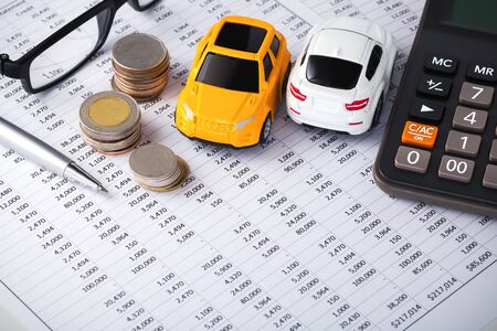 Cars with coins and calculator on financial statement background with spaceの写真素材