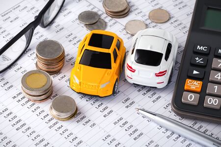 Cars with money and calculator, buying, leasing, car loan, car financeの写真素材