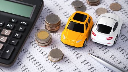 Cars with coins and calculator, buying, leasing, car loan, car financeの写真素材