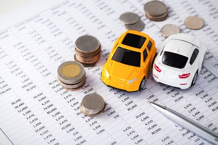 Cars with coins on financial statement, buying, leasing, car loan, car financeの写真素材