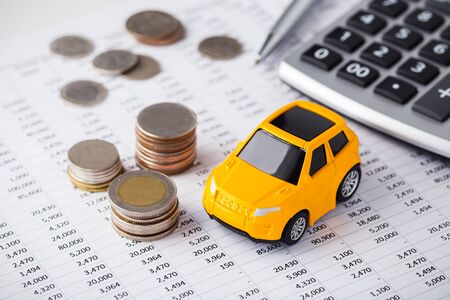 Car with money and calculator on financial statementの写真素材