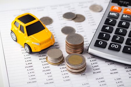 Car and coins with calculator on financial statementの写真素材