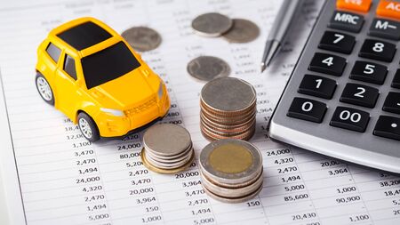 Car and coins with calculator on financial statementの写真素材